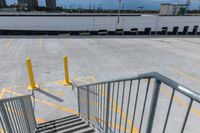 a parking lot with lots of yellow lines and a gray stair with yellow lines at the top and bottom