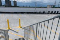 a parking lot with lots of yellow lines and a gray stair with yellow lines at the top and bottom