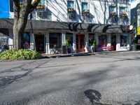 a shadow made into the street with bikes leaning against buildings and a man on a bicycle