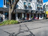 a shadow made into the street with bikes leaning against buildings and a man on a bicycle