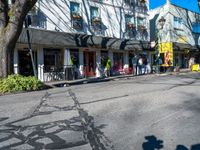 a shadow made into the street with bikes leaning against buildings and a man on a bicycle