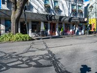 a shadow made into the street with bikes leaning against buildings and a man on a bicycle