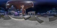 an image of a skateboard park at night time with some people on the skate boards