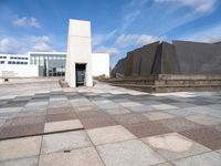 the concretes in front of the building are empty and have different shapes and textures