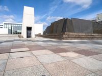 the concretes in front of the building are empty and have different shapes and textures