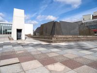 the concretes in front of the building are empty and have different shapes and textures