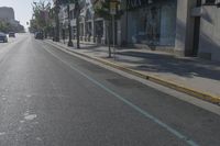 Urban City Road with Low Building and Tree Line