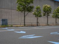 empty road with white lines on the streets of city area against cloudy blue sky on a sunny day