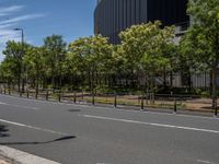 empty road with white lines on the streets of city area against cloudy blue sky on a sunny day