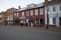 a town street is pictured in this picture with old buildings around it and flags flying out