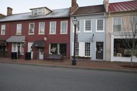 a town street is pictured in this picture with old buildings around it and flags flying out