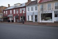 a town street is pictured in this picture with old buildings around it and flags flying out