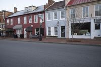 a town street is pictured in this picture with old buildings around it and flags flying out