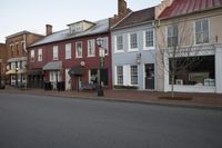 a town street is pictured in this picture with old buildings around it and flags flying out