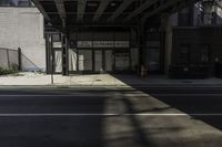 a bus stop on a city street in the daytime sunlight in an urban setting with tall buildings