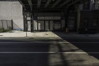 a bus stop on a city street in the daytime sunlight in an urban setting with tall buildings