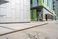 a corner on the sidewalk that has signs and windows in it near buildings and trees