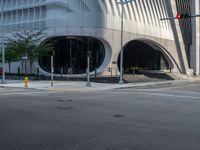 a crosswalk that is on a street near some buildings near some bushes and trees