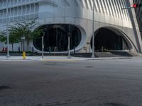 a crosswalk that is on a street near some buildings near some bushes and trees