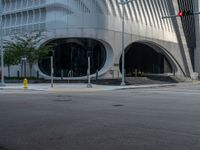 a crosswalk that is on a street near some buildings near some bushes and trees