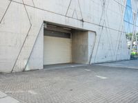 the door to an industrial looking building is opened, revealing a large parking space below