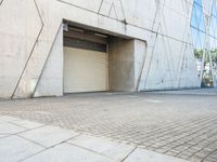 the door to an industrial looking building is opened, revealing a large parking space below