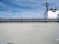 there is a blue sky in the background of this picture, an industrial facility has a large metal pipe and water treatment system