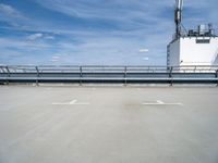 there is a blue sky in the background of this picture, an industrial facility has a large metal pipe and water treatment system