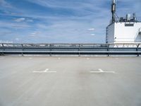 there is a blue sky in the background of this picture, an industrial facility has a large metal pipe and water treatment system