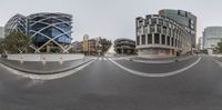 two pictures of some buildings and a street and one is blurred with motion or other