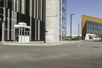 an empty street lined with yellow buildings and tall windows, a white sign and a car is parked in front