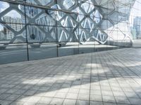 a skateboarder is standing in front of a modern building that has geometric shapes on it