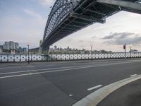 an image of some bridge over a highway in the day time setting with a stoplight on