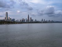 an industrial area in the city with water and sky in background at dusk on a cloudy day