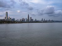 an industrial area in the city with water and sky in background at dusk on a cloudy day