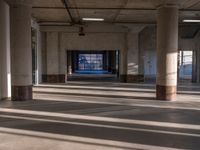 the sunlight shines through the window of an empty building filled with columns and pillars