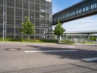 a highway and street view in an urban city with buildings and trees in the background