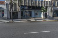 the store front of zara by a street with palm trees and building in the background