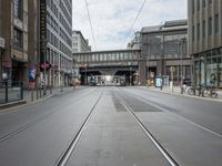 train tracks leading through a city street on a cloudy day in europe for example, train lines are not connected