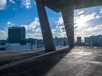 the sun shines brightly on the cityscape outside a glass building, which is almost empty,