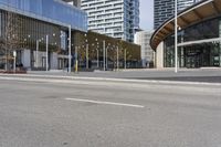 an empty street with buildings and an urban street scene in the background the road has many white lines in it