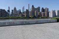 a lone skateboarder is riding past the skyline of new york, ny, as seen in this photo