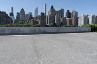 a lone skateboarder is riding past the skyline of new york, ny, as seen in this photo