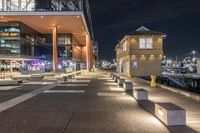 there is a paved walkway along the building's exterior with buildings in the background