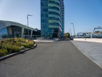 a large building with blue sky in the background and bike rider in front of it