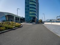 a large building with blue sky in the background and bike rider in front of it