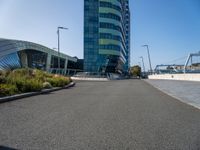 a large building with blue sky in the background and bike rider in front of it