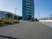 a large building with blue sky in the background and bike rider in front of it