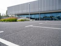 a view of a parking lot from the street in front of the building where they are sitting