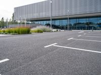 a view of a parking lot from the street in front of the building where they are sitting